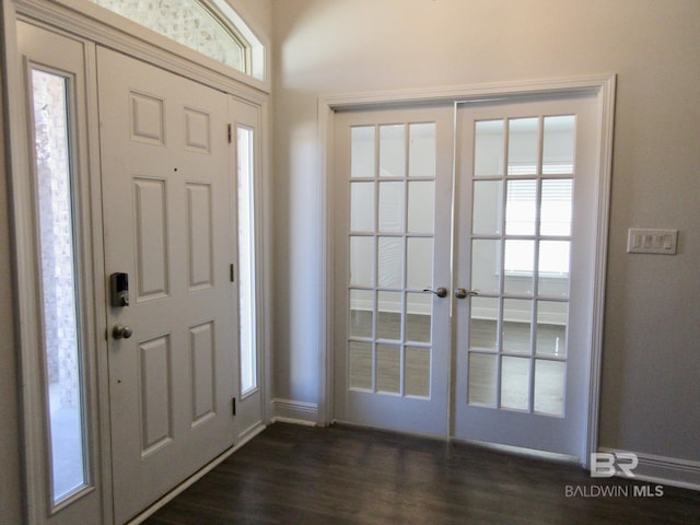 foyer entrance with dark hardwood / wood-style flooring and french doors