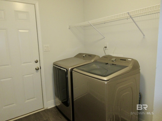 washroom featuring dark wood-type flooring and washer and clothes dryer