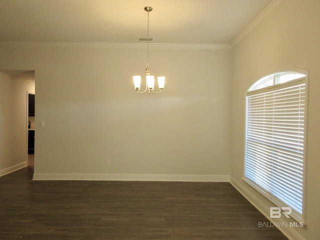 empty room with dark hardwood / wood-style flooring, crown molding, and a chandelier