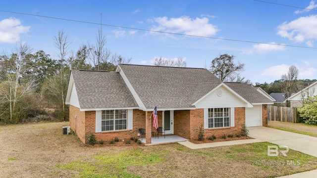 view of front of home with a garage, a porch, and a front lawn