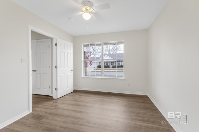 empty room with wood-type flooring and ceiling fan