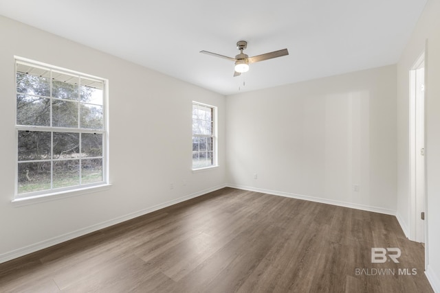 spare room with ceiling fan and dark hardwood / wood-style flooring