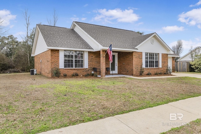 single story home with a front yard and central AC unit