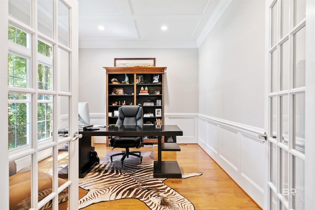 home office with light hardwood / wood-style flooring, crown molding, plenty of natural light, and coffered ceiling