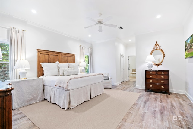 bedroom with ceiling fan, ornamental molding, and light wood-type flooring