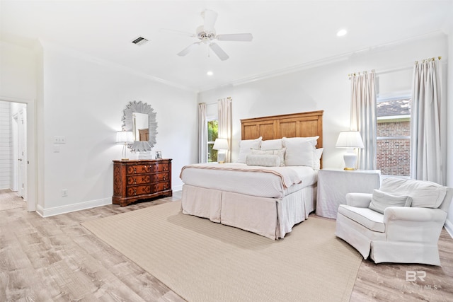 bedroom with ceiling fan, light hardwood / wood-style floors, and ornamental molding