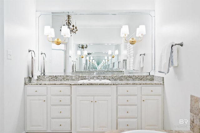 bathroom featuring vanity and an inviting chandelier