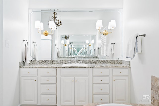 bathroom with vanity and a notable chandelier