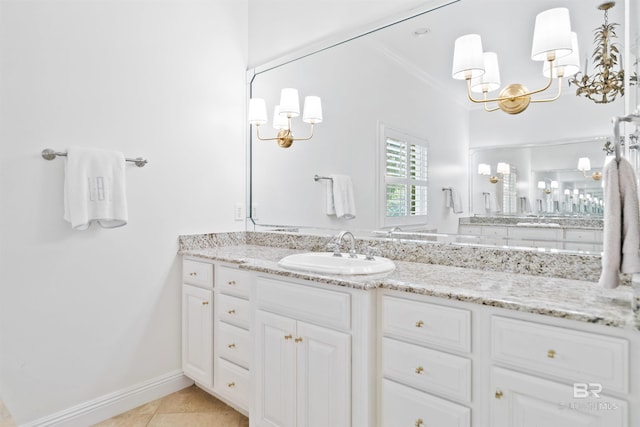 bathroom with tile patterned flooring, vanity, an inviting chandelier, and ornamental molding