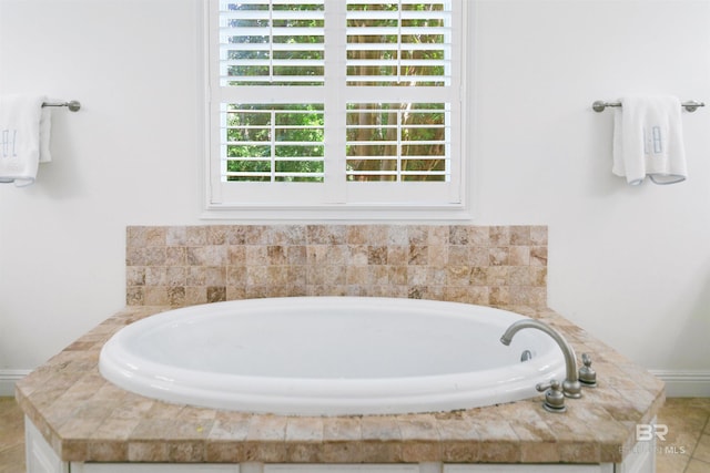 bathroom featuring tiled tub