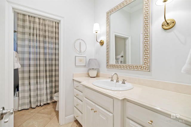 bathroom featuring vanity, toilet, and tile patterned flooring