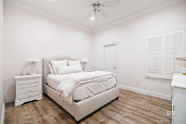 bedroom with hardwood / wood-style flooring, ceiling fan, and ornamental molding