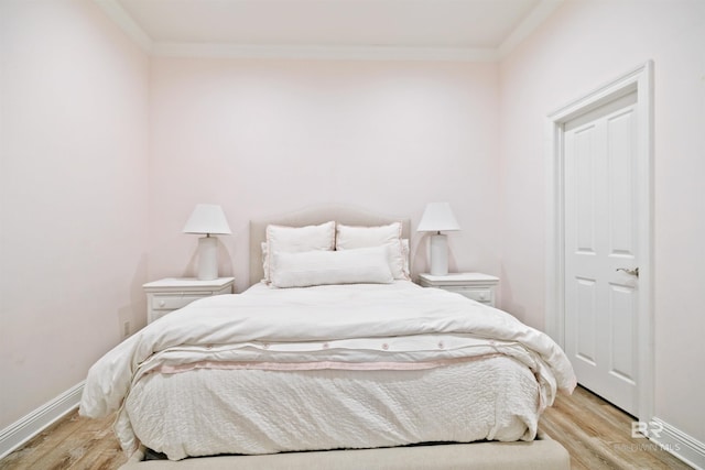 bedroom with crown molding and light hardwood / wood-style flooring