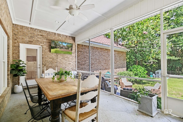 sunroom / solarium featuring ceiling fan