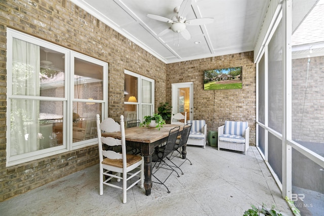 sunroom with ceiling fan and coffered ceiling