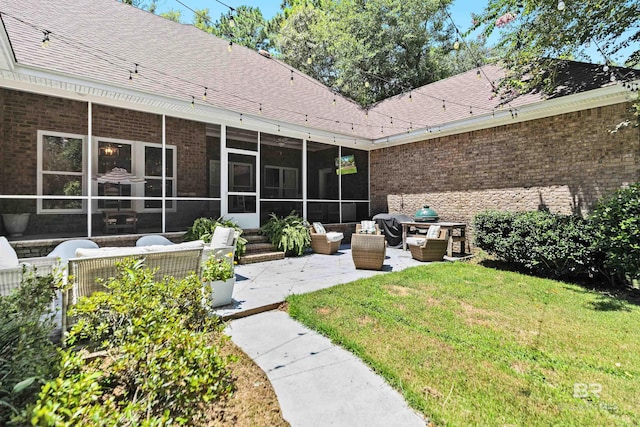 rear view of house with an outdoor hangout area, a patio, a lawn, and a sunroom