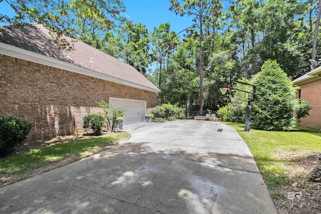 view of home's exterior featuring a garage and a yard