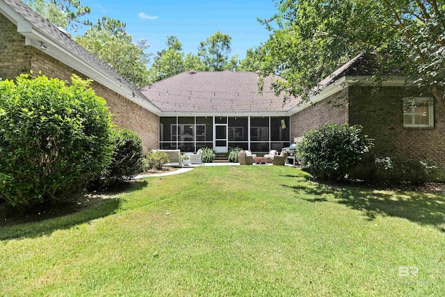 rear view of house featuring a lawn, a sunroom, and an outdoor hangout area