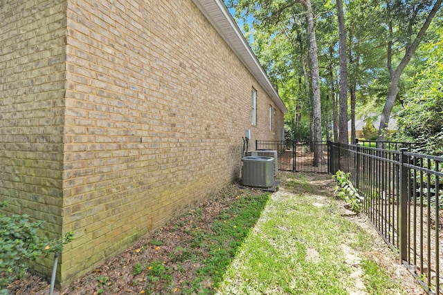 view of side of home with central AC