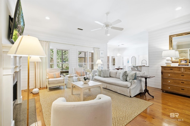 living room with ceiling fan and hardwood / wood-style flooring