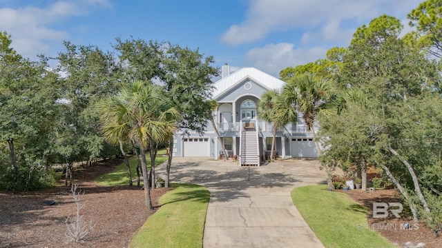 raised beach house with a garage and covered porch