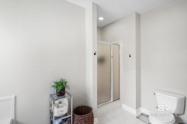 bathroom featuring an enclosed shower, tile patterned floors, and toilet