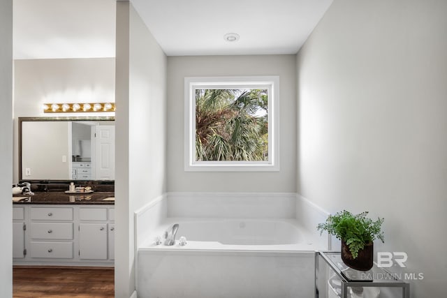 bathroom featuring a bathtub, vanity, and hardwood / wood-style floors