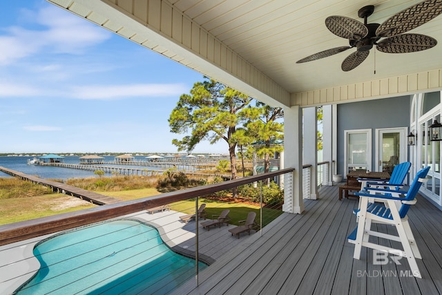 wooden terrace featuring ceiling fan and a water view