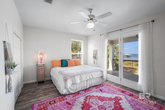 bedroom with dark wood-type flooring, access to outside, and ceiling fan