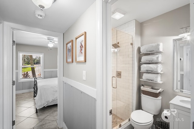 bathroom featuring walk in shower, tile patterned flooring, ceiling fan, vanity, and toilet