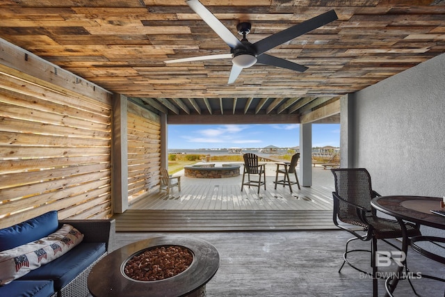 wooden deck featuring an outdoor fire pit and ceiling fan