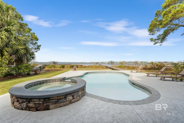 view of swimming pool with a patio and an in ground hot tub