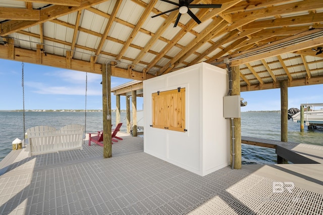 view of patio / terrace featuring a dock, a water view, and ceiling fan