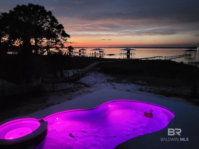 pool at dusk with a water view