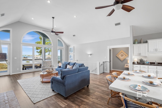 living room featuring ceiling fan, wood-type flooring, sink, and high vaulted ceiling