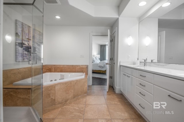 ensuite bathroom with visible vents, ensuite bathroom, a sink, double vanity, and a bath