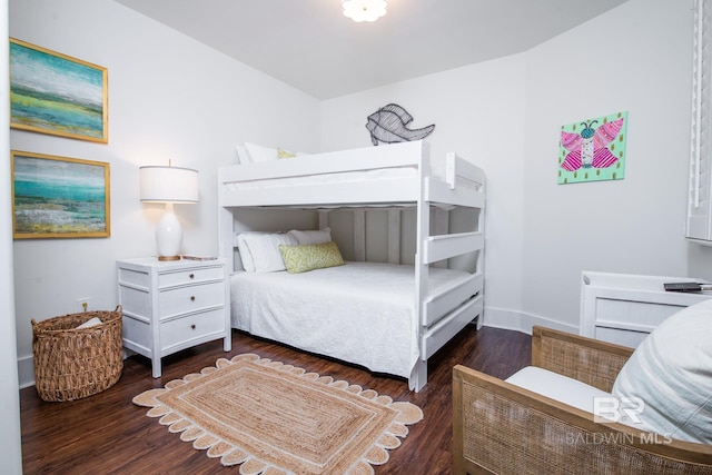 bedroom with baseboards and wood finished floors