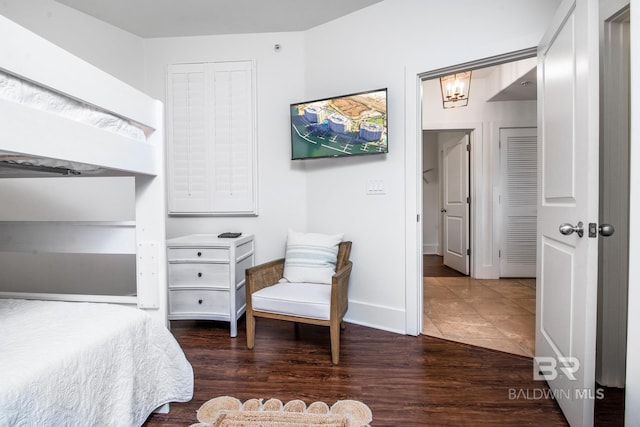 bedroom with baseboards and wood finished floors