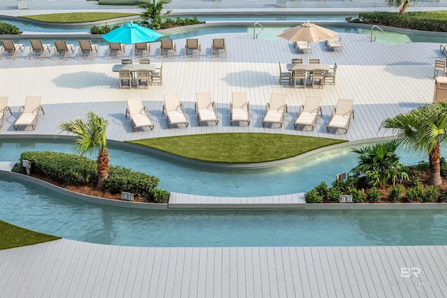 view of swimming pool featuring outdoor dining space