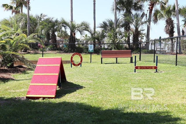 surrounding community featuring fence and a lawn