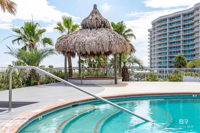 view of swimming pool with a pool and fence