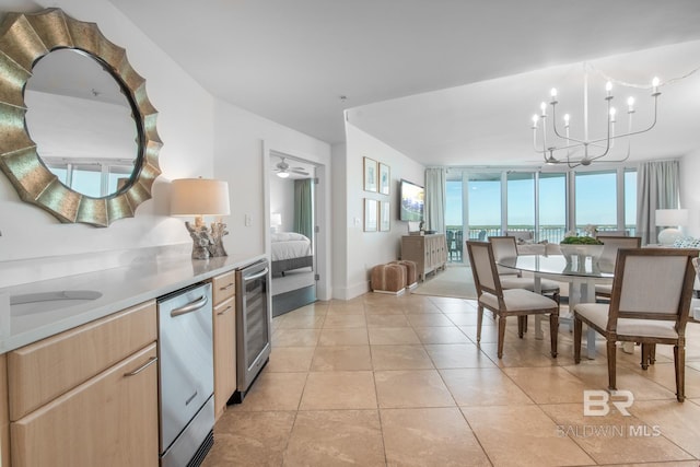 kitchen featuring light brown cabinetry, a sink, wine cooler, light tile patterned flooring, and dishwasher