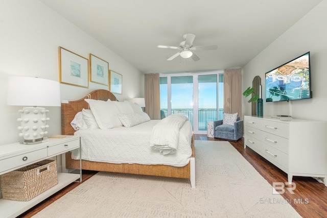 bedroom with a ceiling fan, floor to ceiling windows, access to exterior, and dark wood finished floors