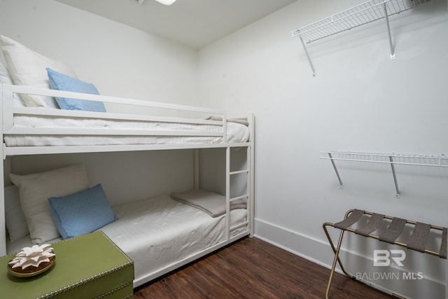 bedroom with baseboards and wood finished floors