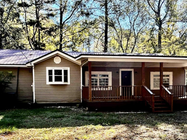 back of house with a lawn and a porch