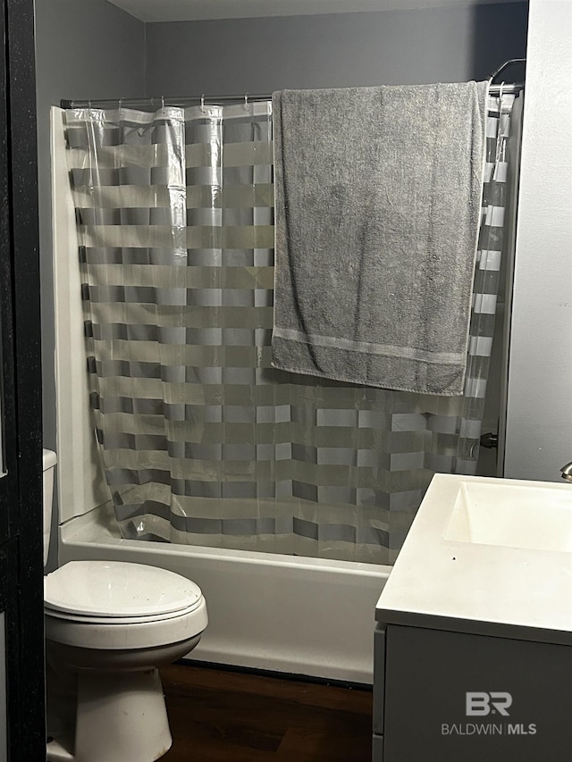 full bathroom with shower / tub combo, vanity, and toilet