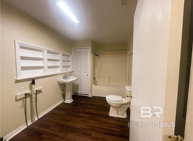 full bathroom featuring hardwood / wood-style flooring, toilet, sink, and bathtub / shower combination