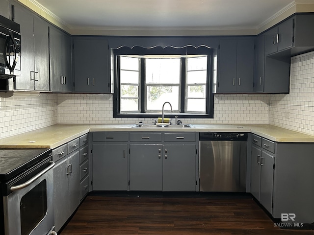 kitchen featuring decorative backsplash, sink, appliances with stainless steel finishes, and dark wood-type flooring