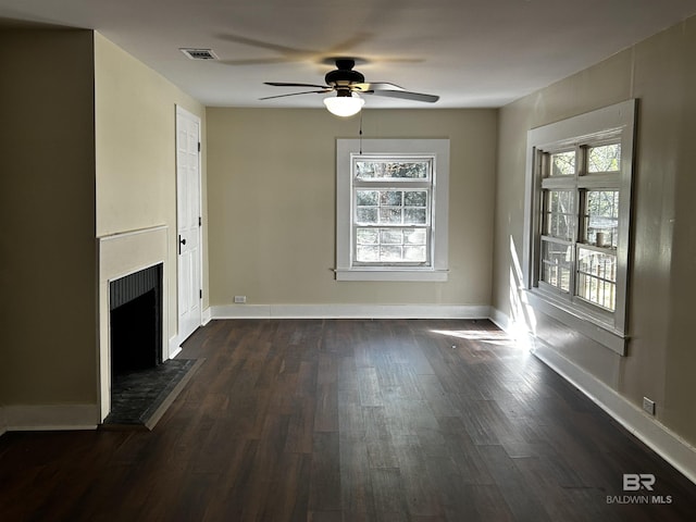 unfurnished living room featuring ceiling fan, dark hardwood / wood-style flooring, and a wealth of natural light