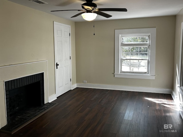 unfurnished living room featuring dark hardwood / wood-style floors and ceiling fan